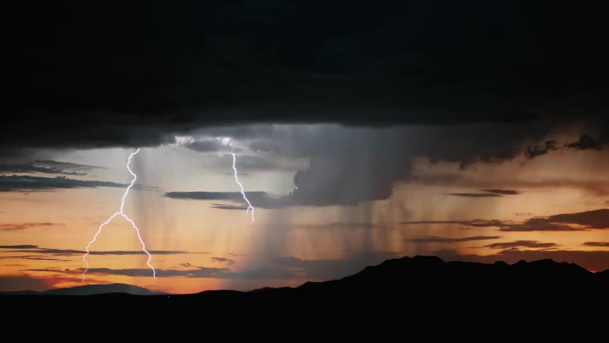 A lightening storm at sunset with dark clouds
