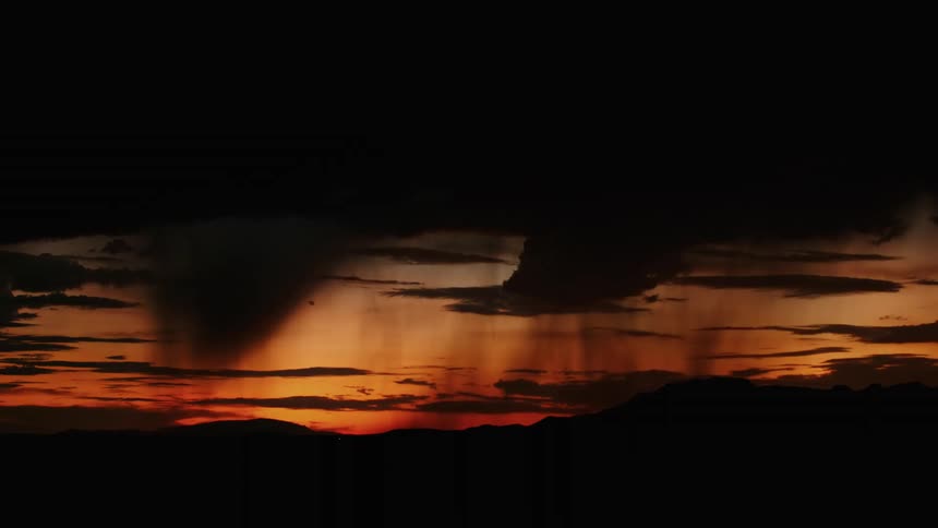 Lightning storm cutting through the cloudy sky at sunset