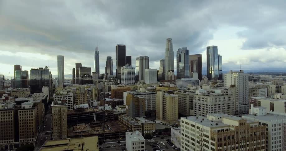 Clouds float over city buildings