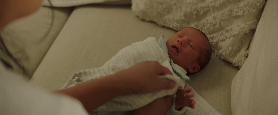 A mother wraps her son in a blanket