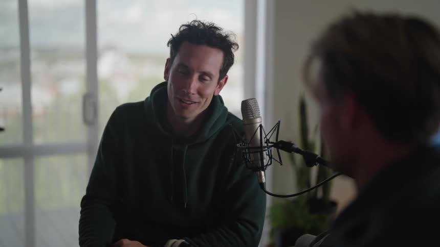 Two men shake hands after a studio session