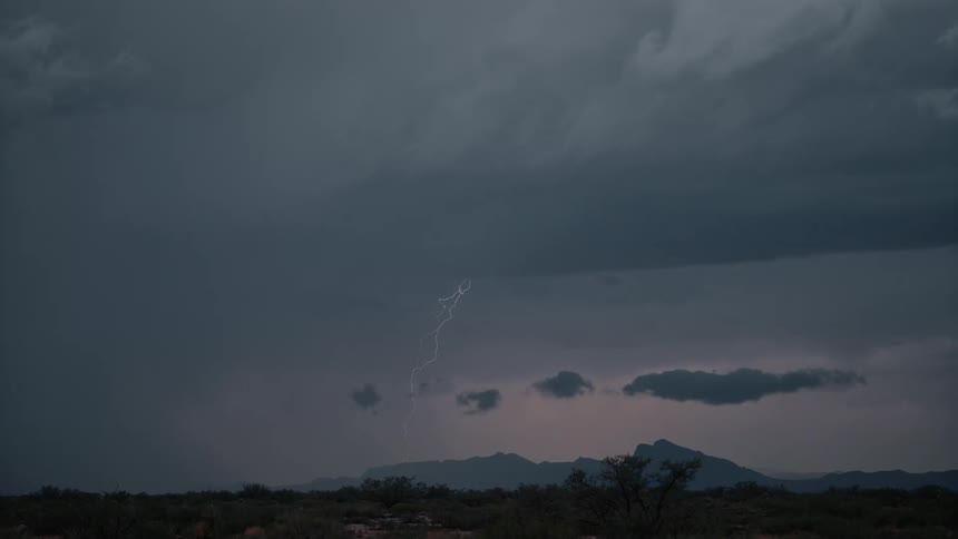 Lightning strikes the mountains at sunset