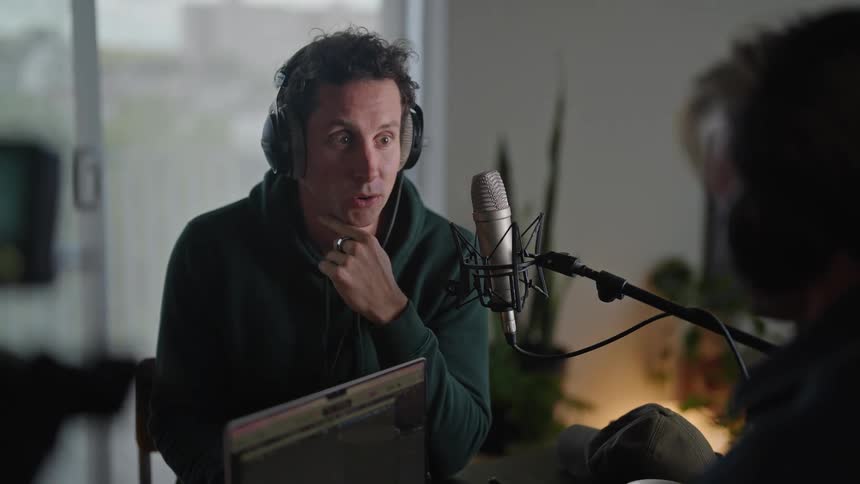 Two men inside the studio having discussions