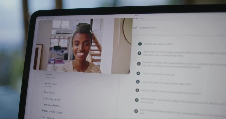 Computer screen with a video conference where a smiling woman is talking