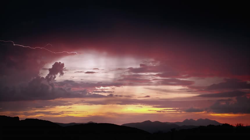 Red sky in the morning with strong gusts of thunder under the mountains