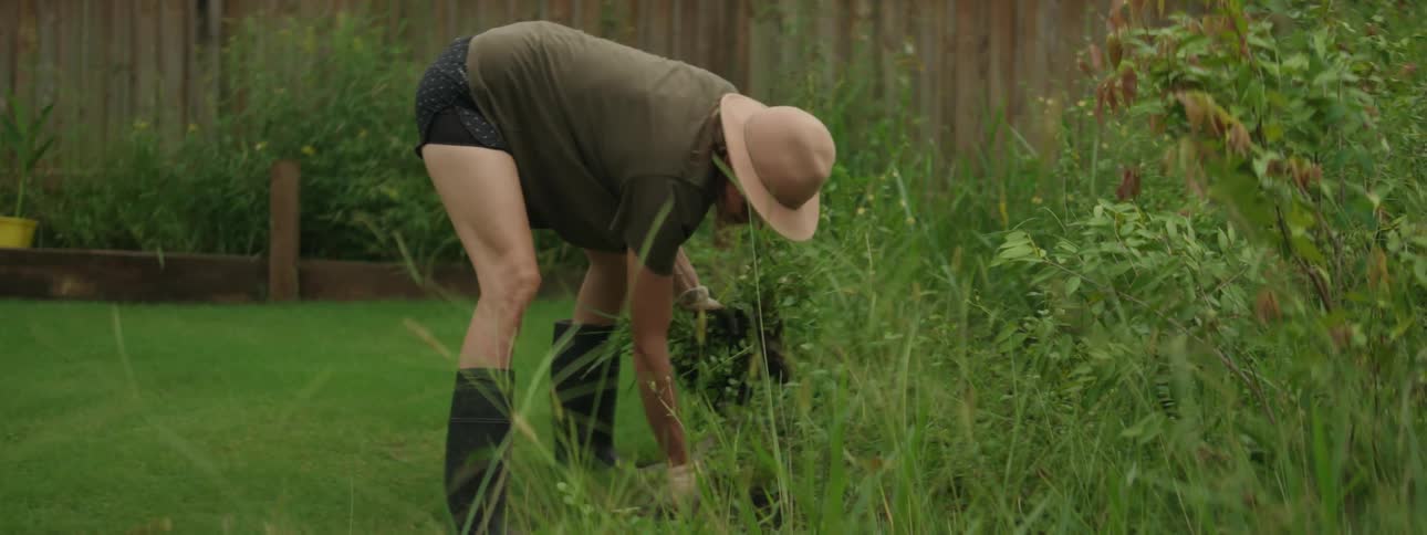 Person digging the earth in her vegetable garden