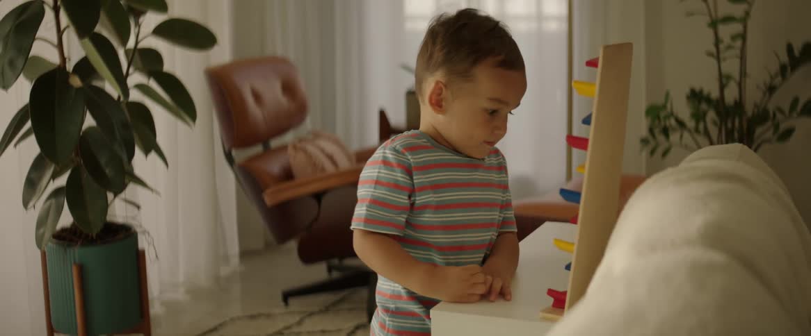 Standing child playing with playful toy