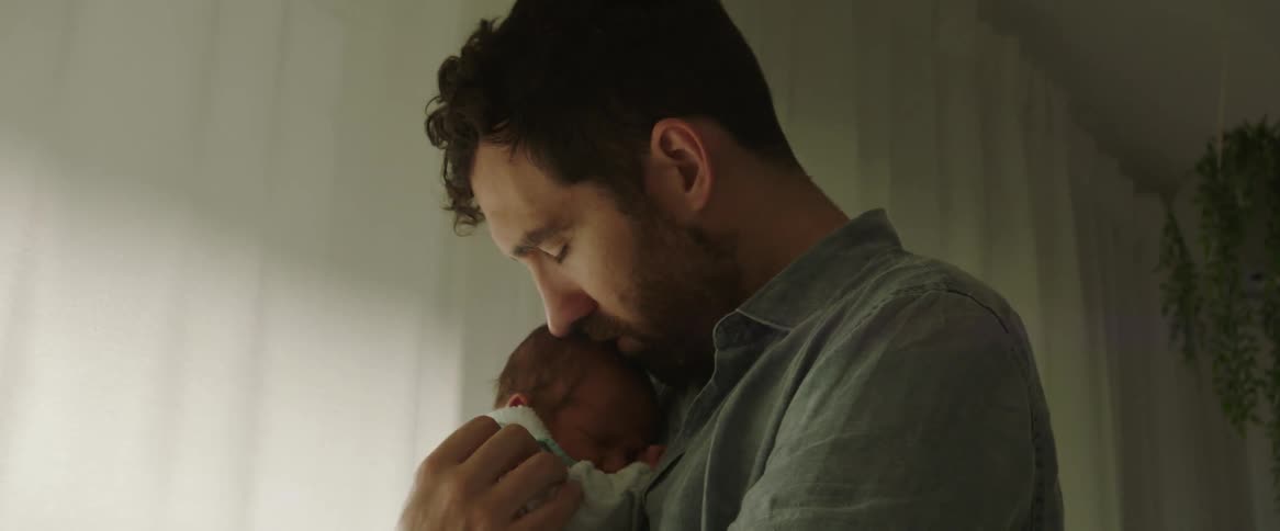 Father hugging and kissing his newborn son