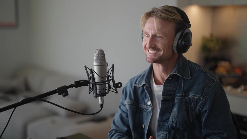 A man in the studio talking to the microphone