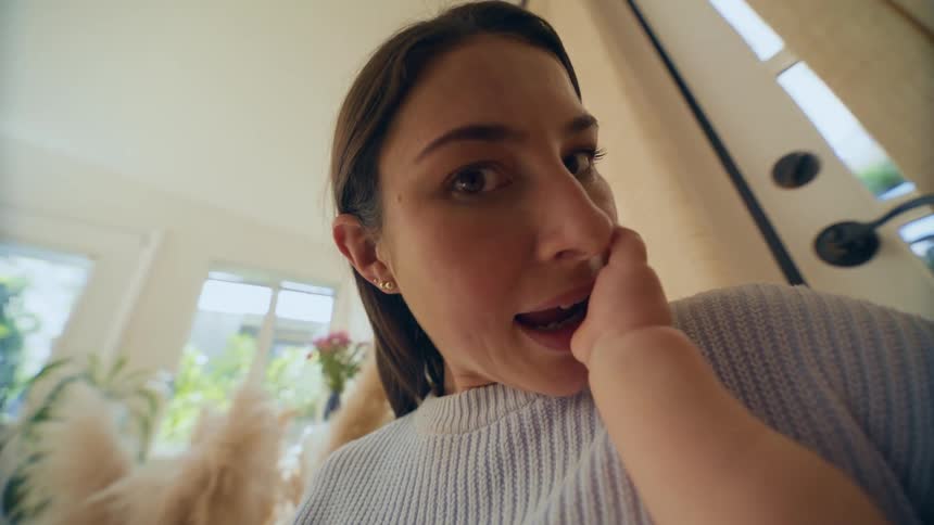 Mother playing with baby son at home