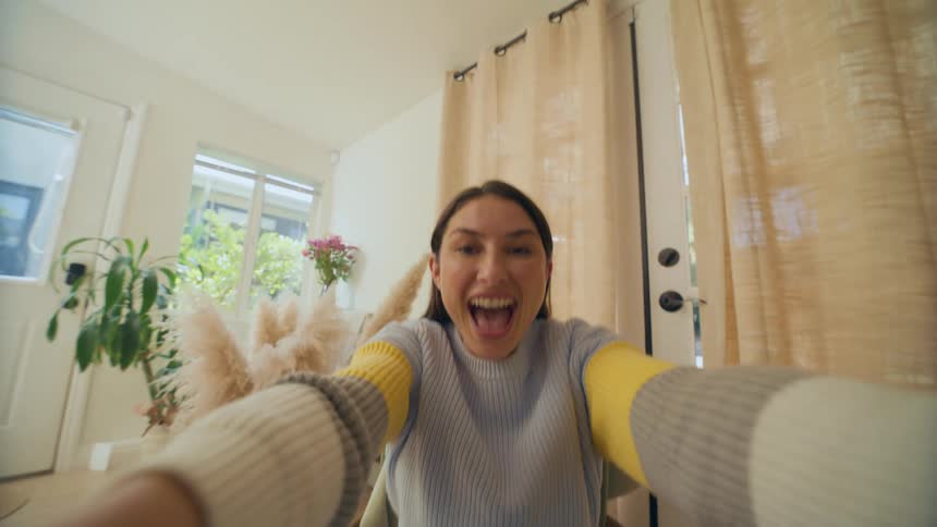 Lady smiling indoor while sited on a chair