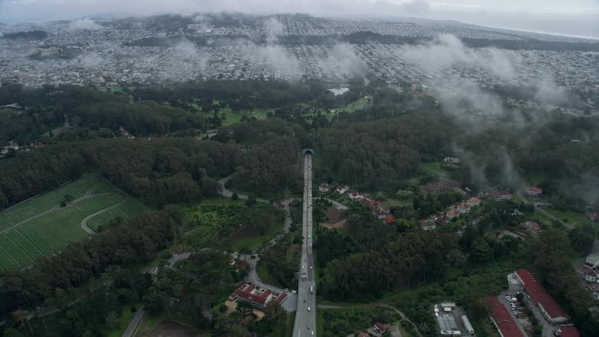 Aerial footage of Veterans Blvd leading to the MacArthur Tunnel in The Presidio San Francisco California on a cloudy day