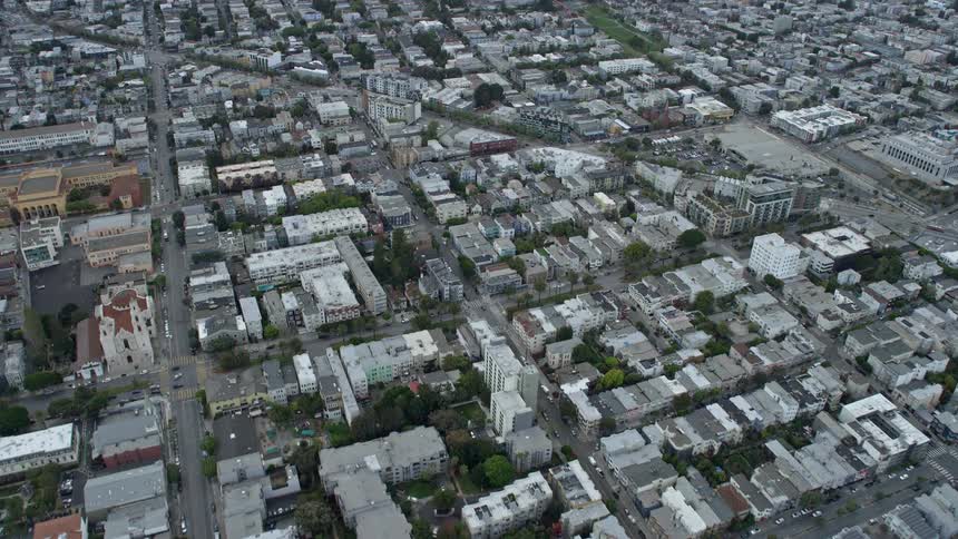  aerial footage of apartment buildings in the Mission District of San Francisco California showcasing a cloudy day and a stunning fly-over approach to the residential area