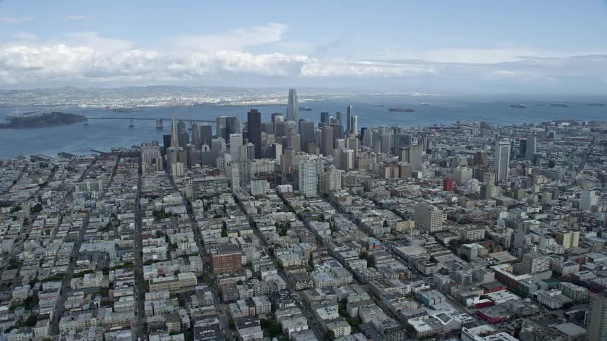  aerial footage approaching the downtown San Francisco skyline from Pacific Heights California on a cloudy day capturing the high-rise buildings and cityscape of the bustling city