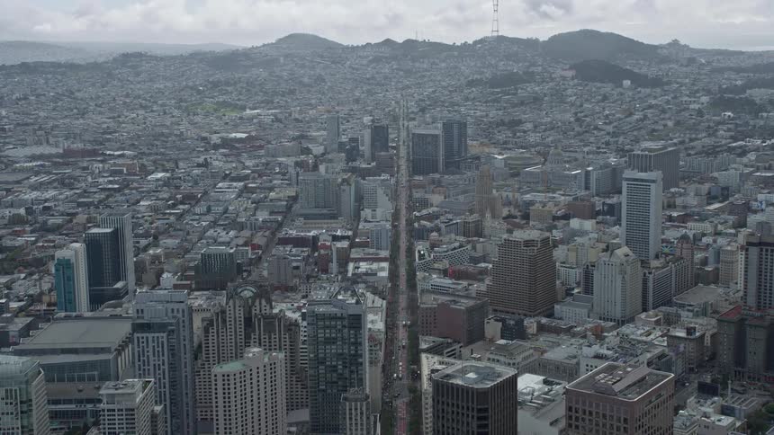 Aerial view of Market Street in San Francisco California with office buildings and busy city streets below on a cloudy day