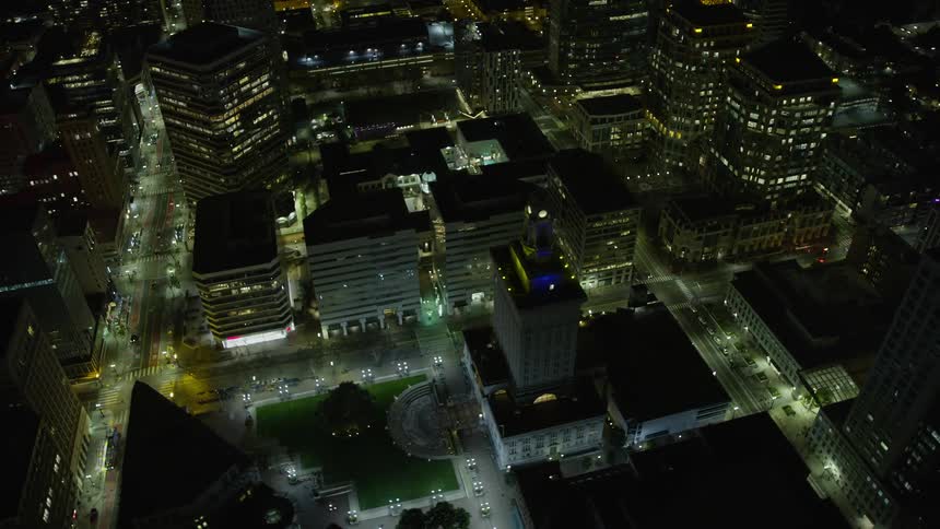  aerial footage of Oakland City Hall in Downtown Oakland at night with clear skies and office buildings in the background capturing the beauty of the city and its municipal government