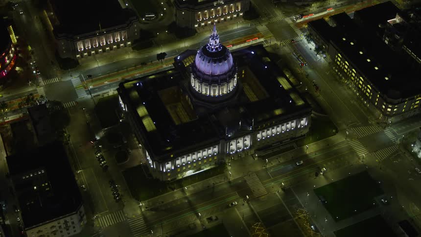  aerial footage showcasing the iconic San Francisco City Hall at night with clear skies and a reverse approaching POV perspective capturing the beauty of the city and its government building in Northern California SF Bay Area West Coast
