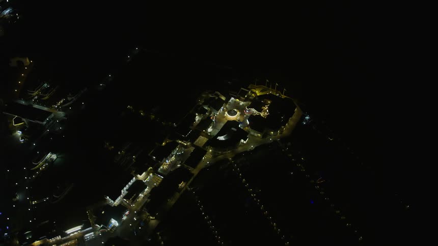 anaerial footage showcasing the iconic Pier 39 at night offering a bird's eye view of the dazzling lights and vibrant cityscape of San Francisco California