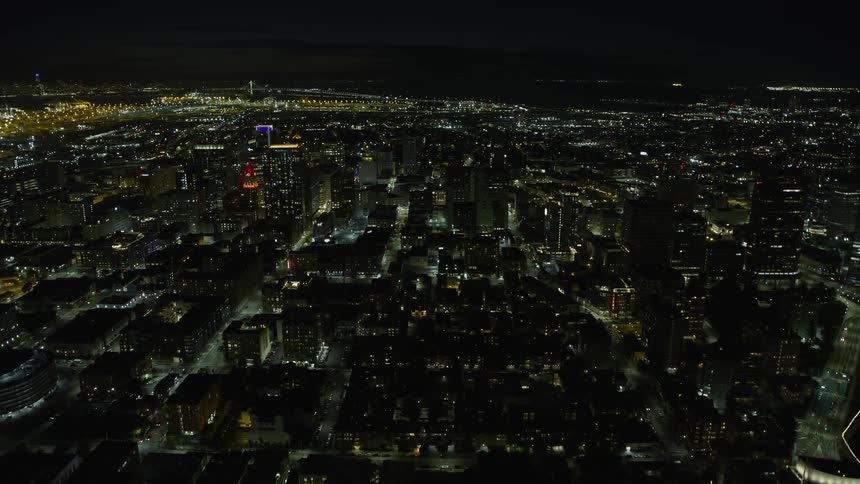 A captivatingaerial view of Downtown Oakland office buildings at night as seen from Lake Merritt in California showcasing clear skies and the mesmerizing beauty of the city