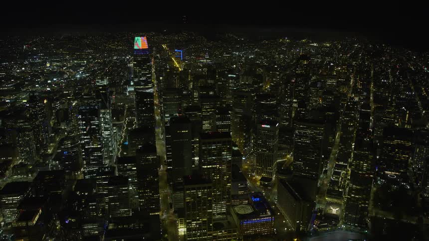  aerial footage of Salesforce Tower and surrounding skyscrapers in Downtown San Francisco at night showcasing the high rises and modern buildings with clear skies above