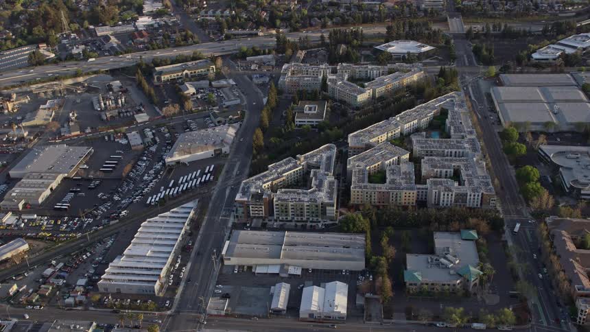  aerial footage captures the hazy beauty of San Jose apartment complexes at sunset in California's Bay Area