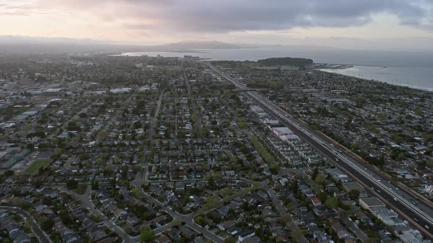  aerial footage capturing the picturesque San Mateo suburban neighborhoods at sunset revealing the beauty of a residential partly cloudy evening in this Bay Area bedroom community