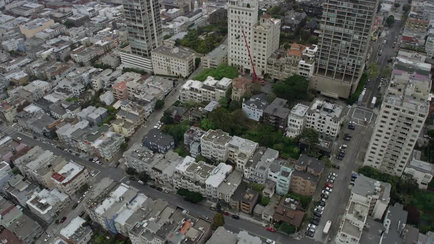 Aerial footage of Russian Hill apartment buildings in San Francisco on a foggy day showcasing the residential area in the city