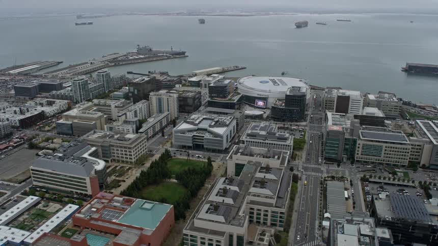  aerial footage of office buildings near the San Francisco arena on a foggy day providing a unique perspective of the city's industrial and entertainment areas during daytime