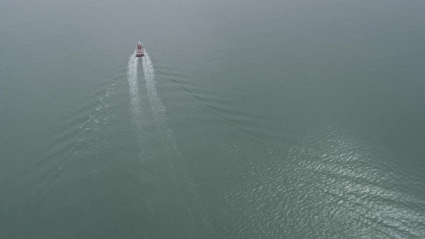  aerial footage of ferries sailing through the foggy San Francisco Bay on a summer day in San Francisco California showcasing the maritime atmosphere of the Bay Area