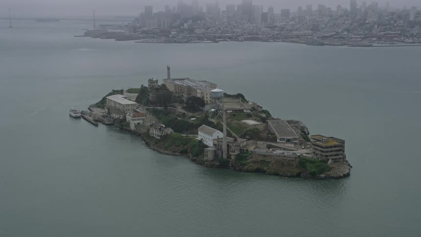  aerial footage showcasing a foggy day in California with a stunning view of Alcatraz Island and the Golden Gate Bridge in the background