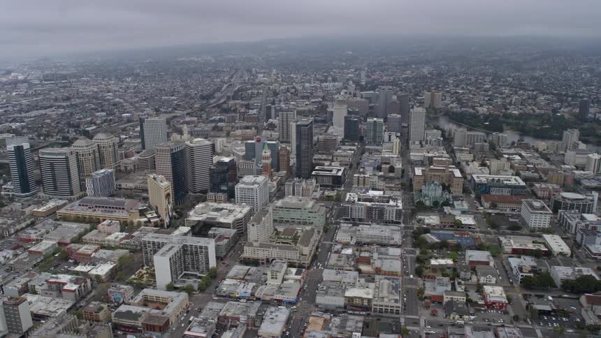 Aerial footage of foggy Downtown Oakland on a summer day showcasing office buildings and the bustling cityscape of Northern California