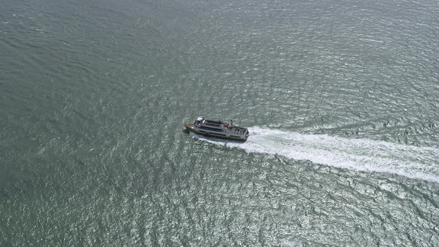  aerial footage of a ferry sailing on San Francisco Bay California showcasing the seafaring journey with cloudy skies and shotover technology capturing the passage boats in the scenic San Francisco Peninsula