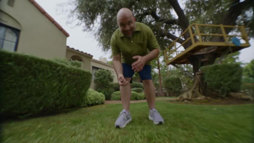 Dog jumps onto man in the backyard