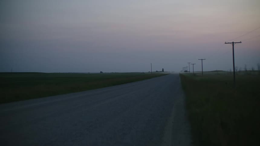 Clear one lane road in the rural at dusk