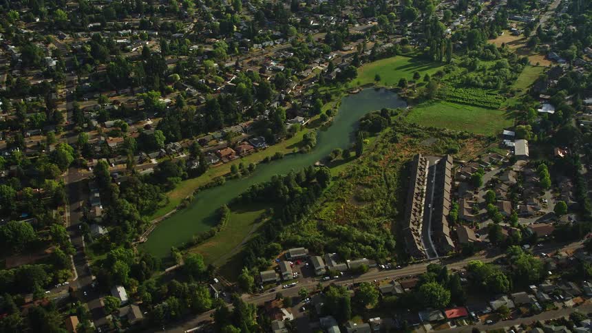 Aerial footage showcasing a serene lake surrounded by suburban houses in Beaverton Oregon