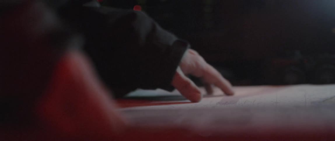 A man's hands are examining a nautical chart