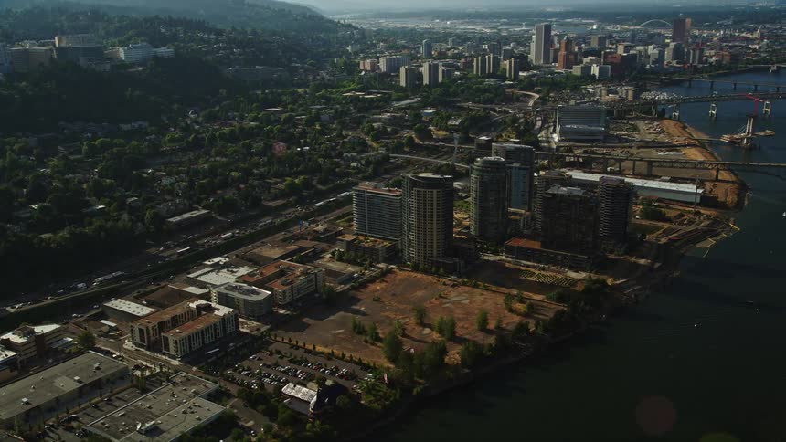 Aerial footage showcasing the high-rise district cityscape and waterfront areas of Portland Oregon during daylight hours