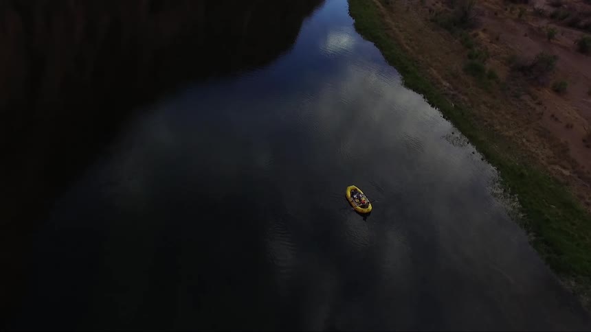 A raft floats on a calm river
