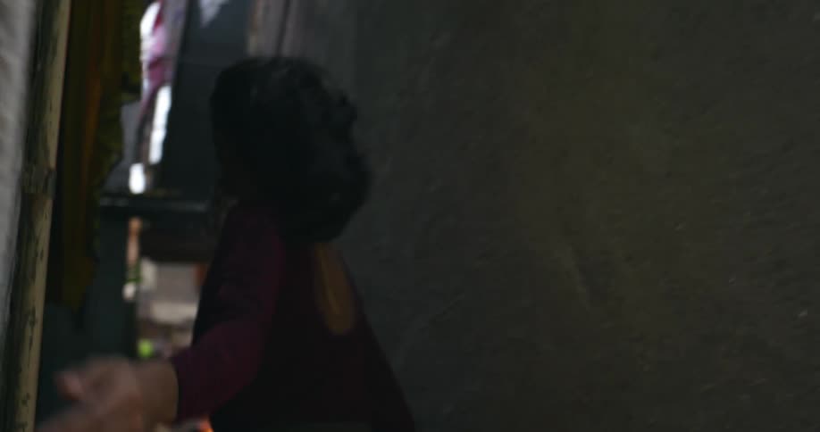 Woman turns down narrow alley between buildings