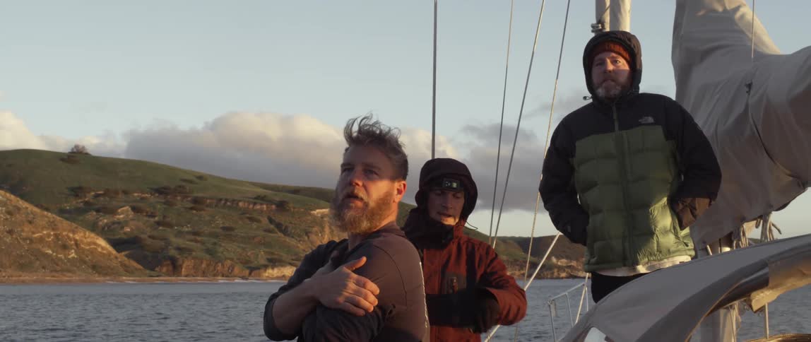 Three people are on a boat together