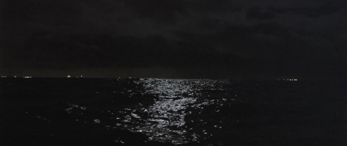 Moonlight shining on rough ocean waters