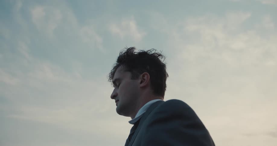 A businessman in a suit with a look of worry and sadness