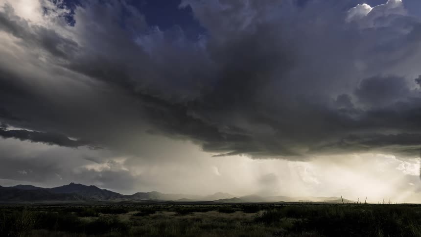 Storm clouds and rain over the plains at daytime