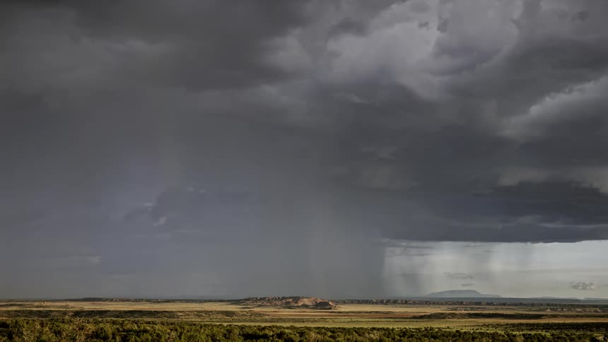 A timelapse of a huge tornado cloud over an open field
