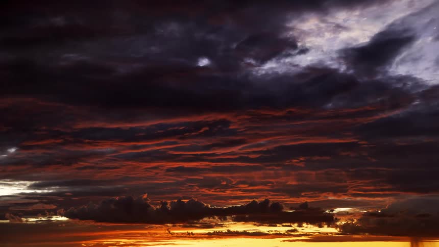 Heavy clouds move in the dark sky