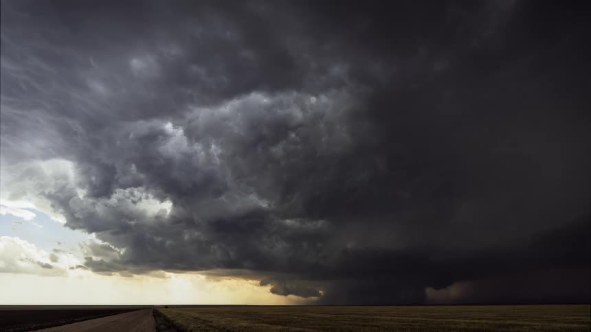 A big black storm cloud moving across the sky