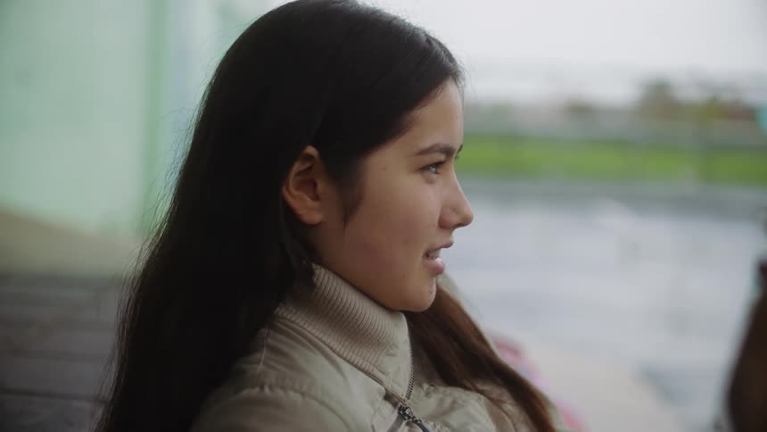 Profile of a young attractive woman with long hair talking