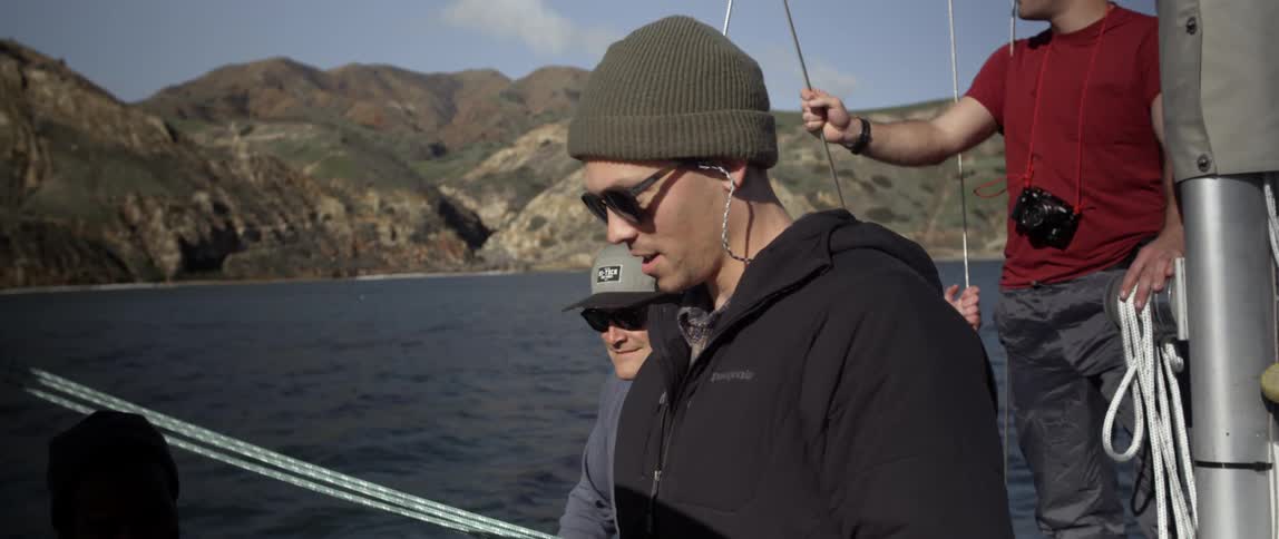 Men are on a boat looking over the edge