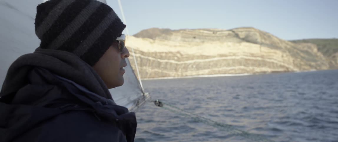 A man is looking over the side of a boat