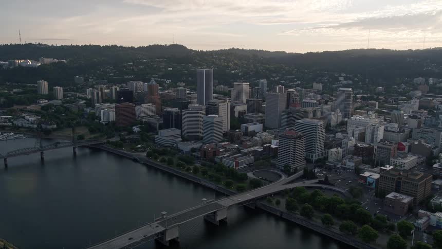 A stunning aerial view of downtown Portland Oregon at sunset showcasing the Morrison Bridge and the city skyline